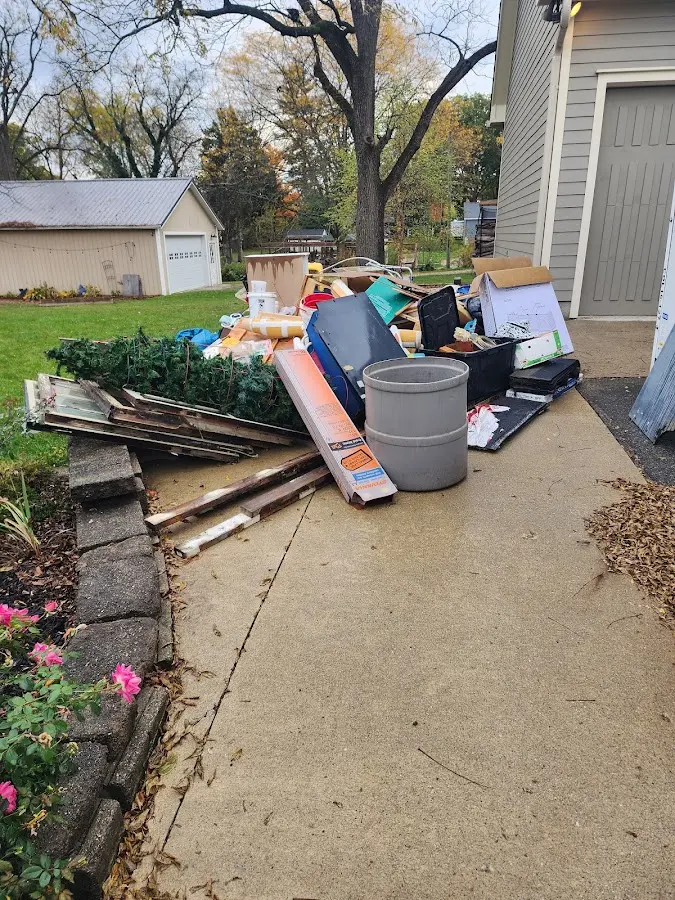 Dumpster being loaded with debris for 30 Yard Dumpster Rental in Hutchinson